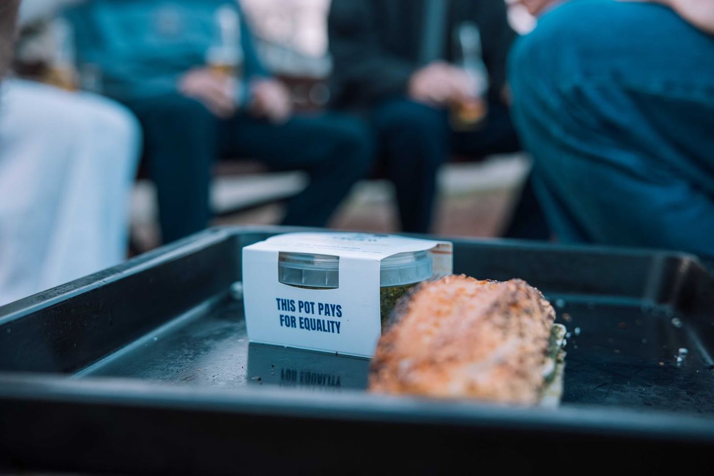 A Crush pot reading This pot pays for equality on a serving tray